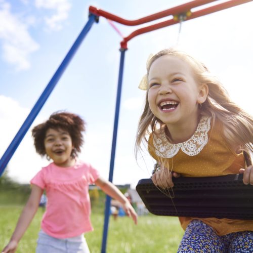 close-up-young-beautiful-girls-playing-with-swing-min